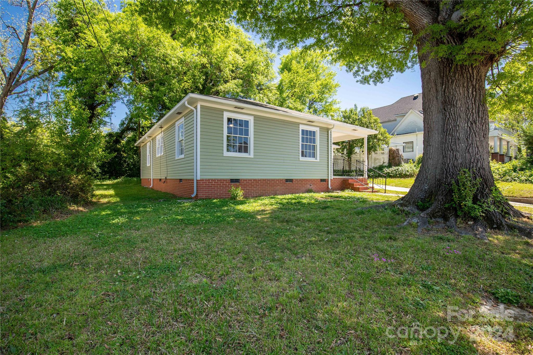 303 North White Street Lancaster, SC 29720 - Photo 21 of 24 a backyard of a house with lots of green space
