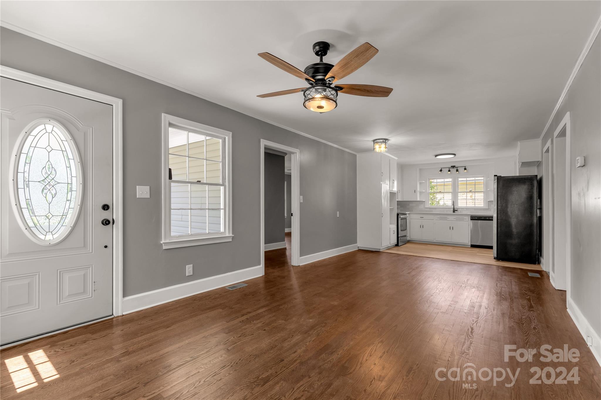 303 North White Street Lancaster, SC 29720 - Photo 4 of 24 a view of an empty room with wooden floor and a window