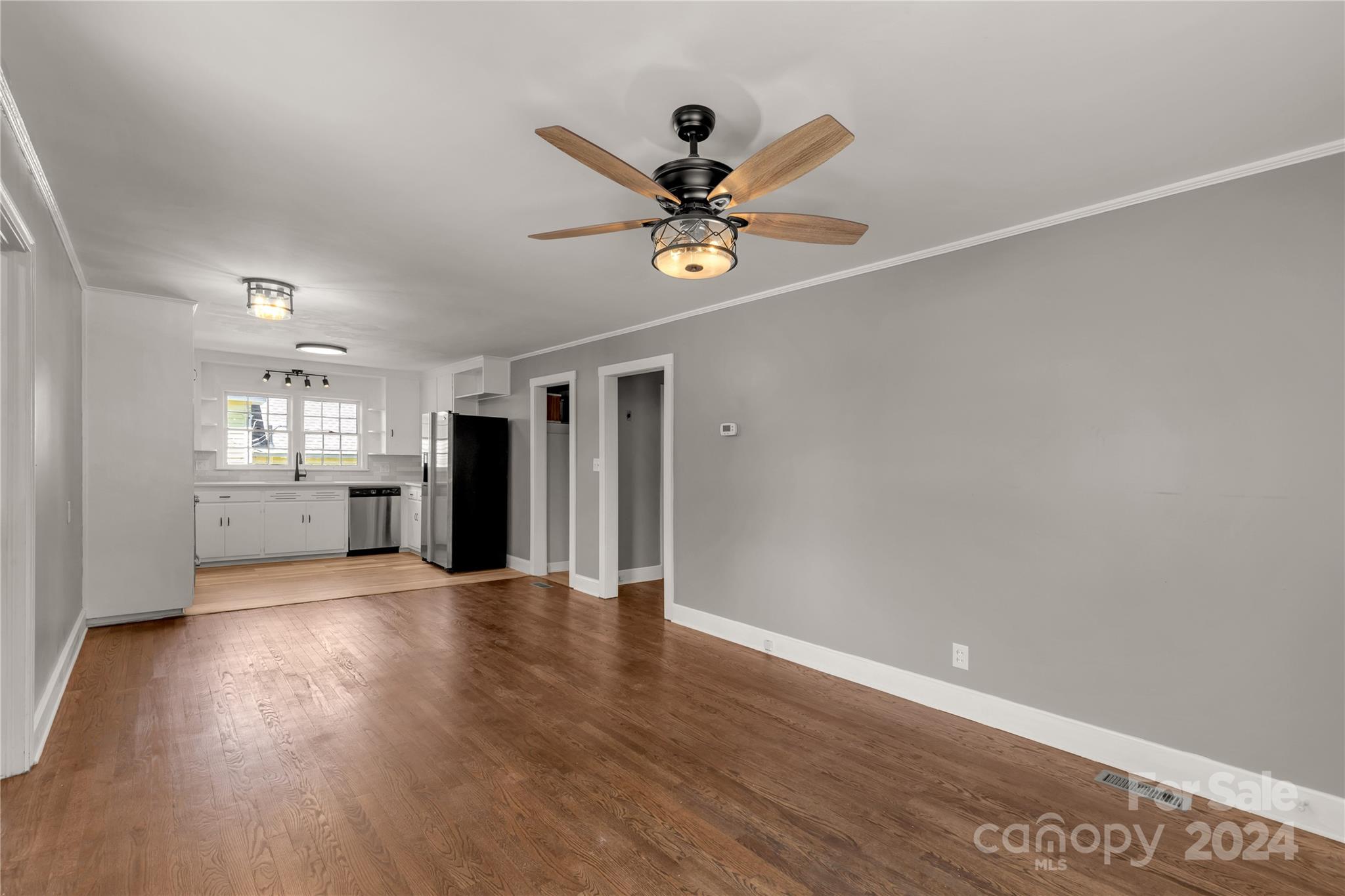 303 North White Street Lancaster, SC 29720 - Photo 5 of 24 a view of an empty room with window and wooden floor