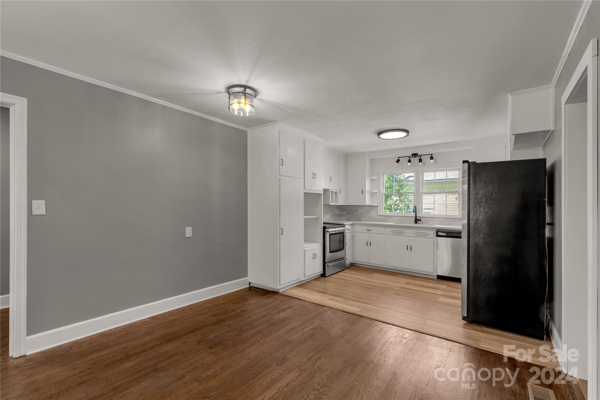 303 North White Street Lancaster, SC 29720 - Photo 6 of 24 a kitchen with a refrigerator and a stove top oven