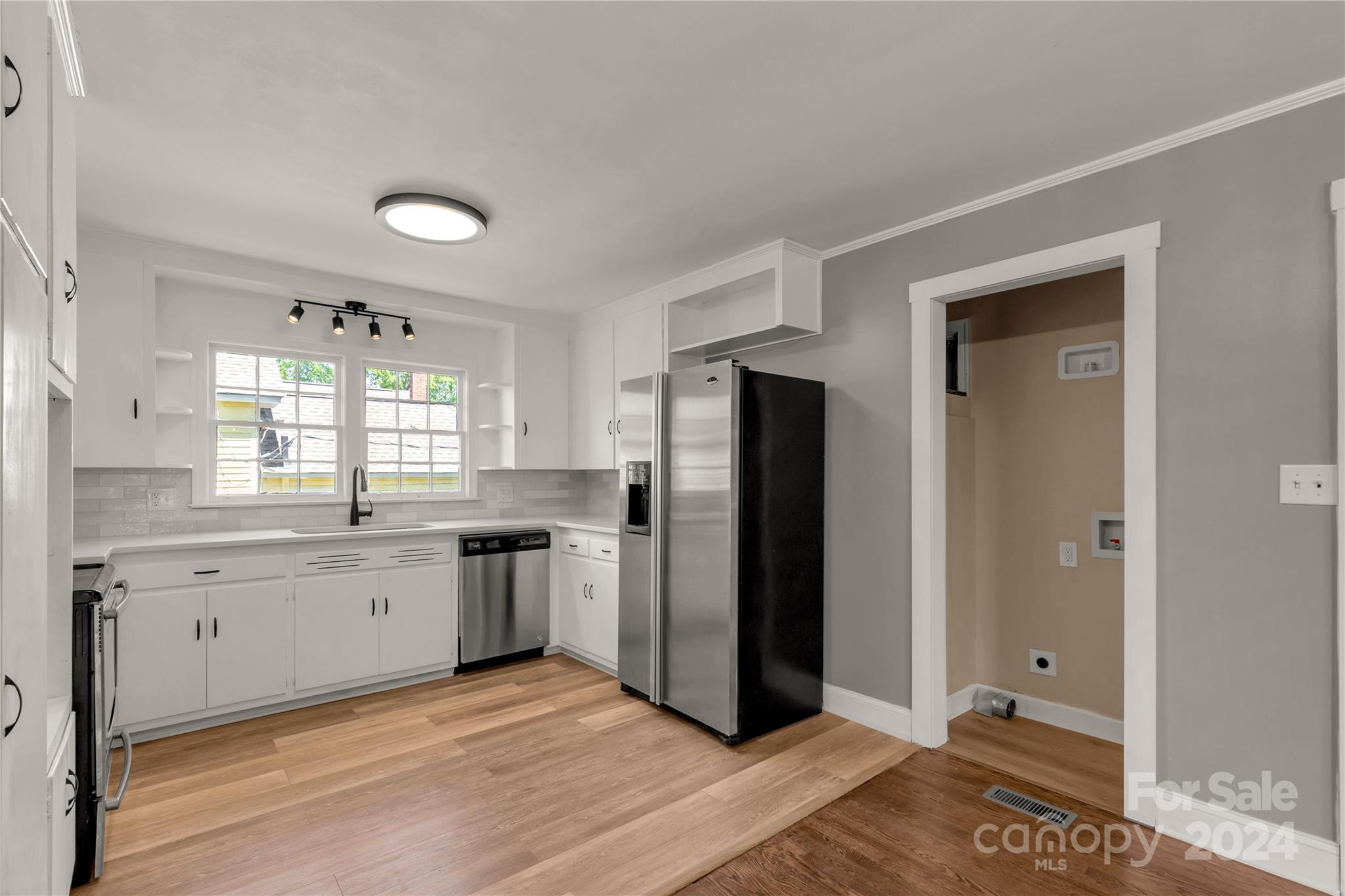 303 North White Street Lancaster, SC 29720 - Photo 8 of 24 a kitchen with stainless steel appliances granite countertop a refrigerator and a stove