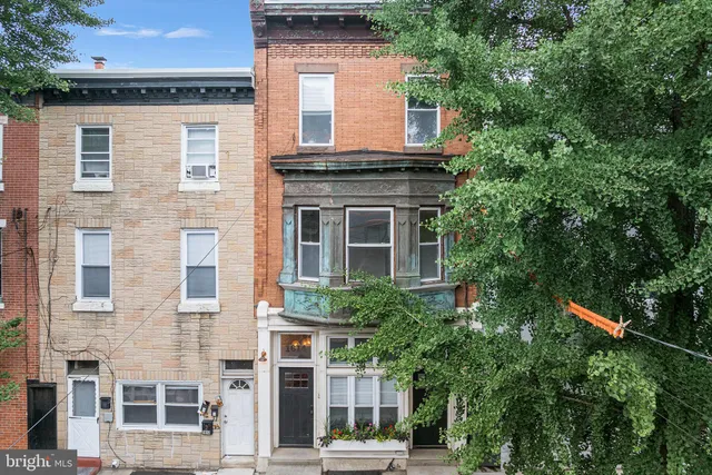 front view of a house with a tree