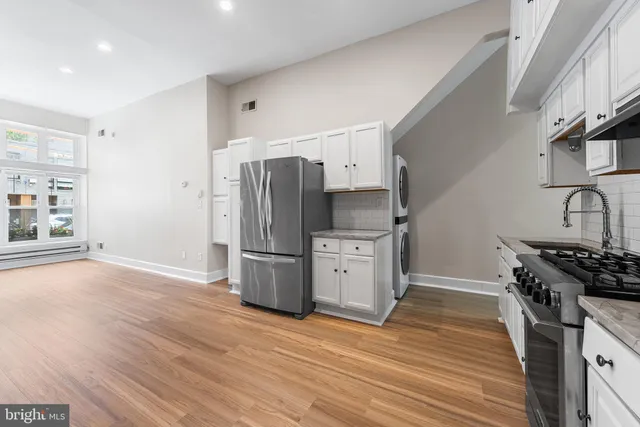 a view of a bedroom with washer and dryer