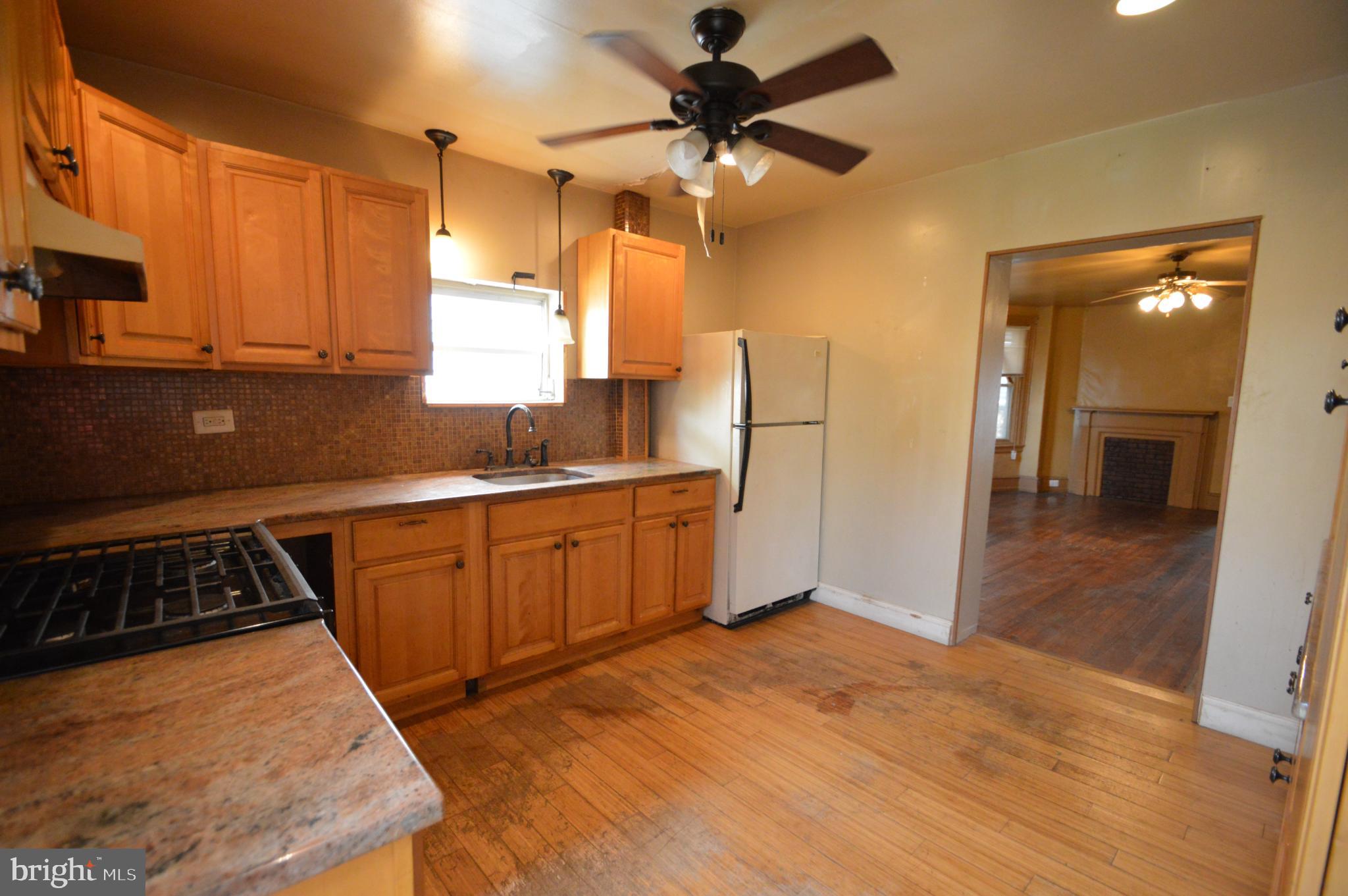 6011 Sansom Street Philadelphia, PA 19139 - Photo 12 of 24 a kitchen with sink a refrigerator and cabinets
