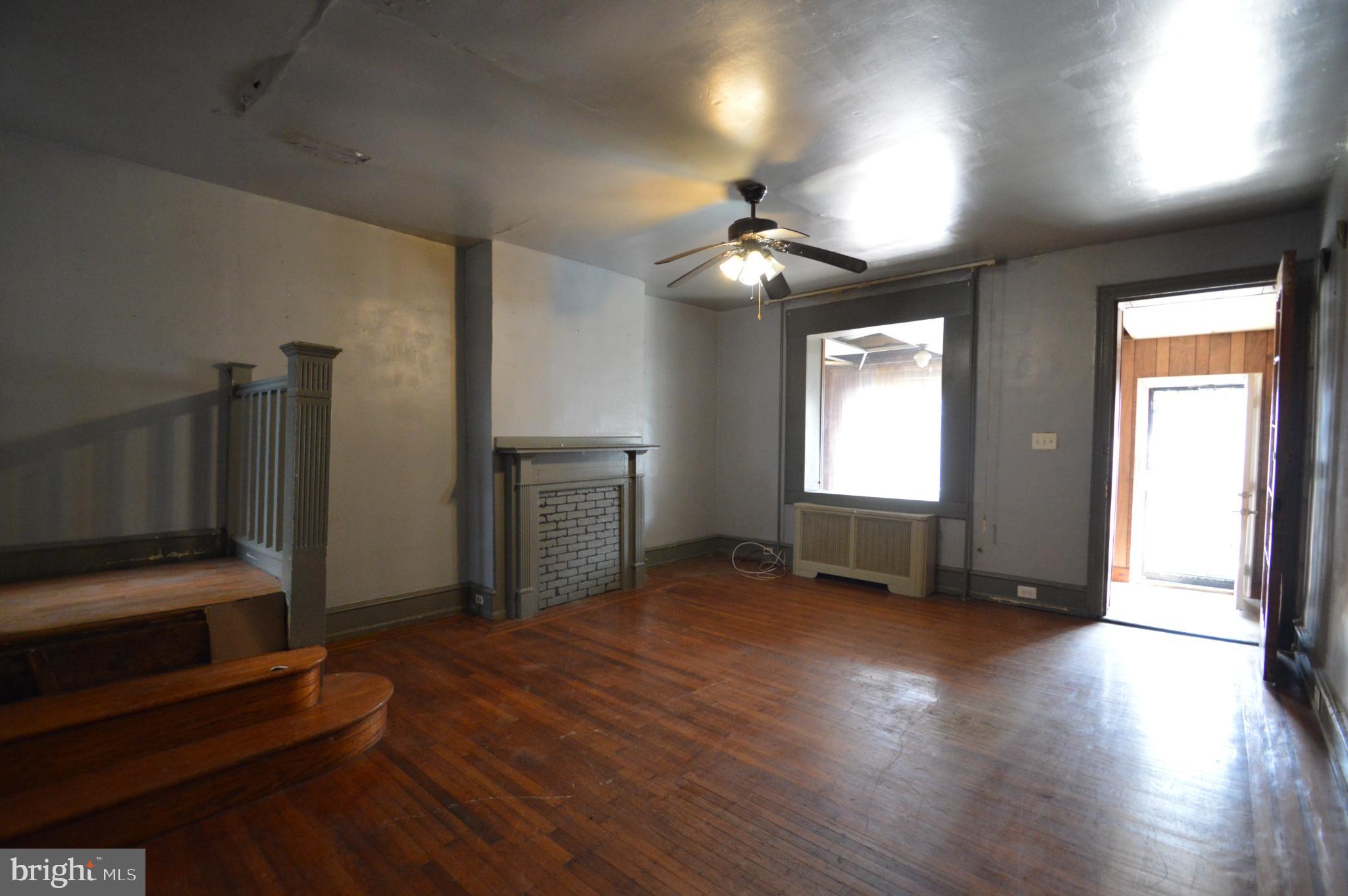 6011 Sansom Street Philadelphia, PA 19139 - Photo 2 of 24 a view of a livingroom with furniture wooden floor and a window