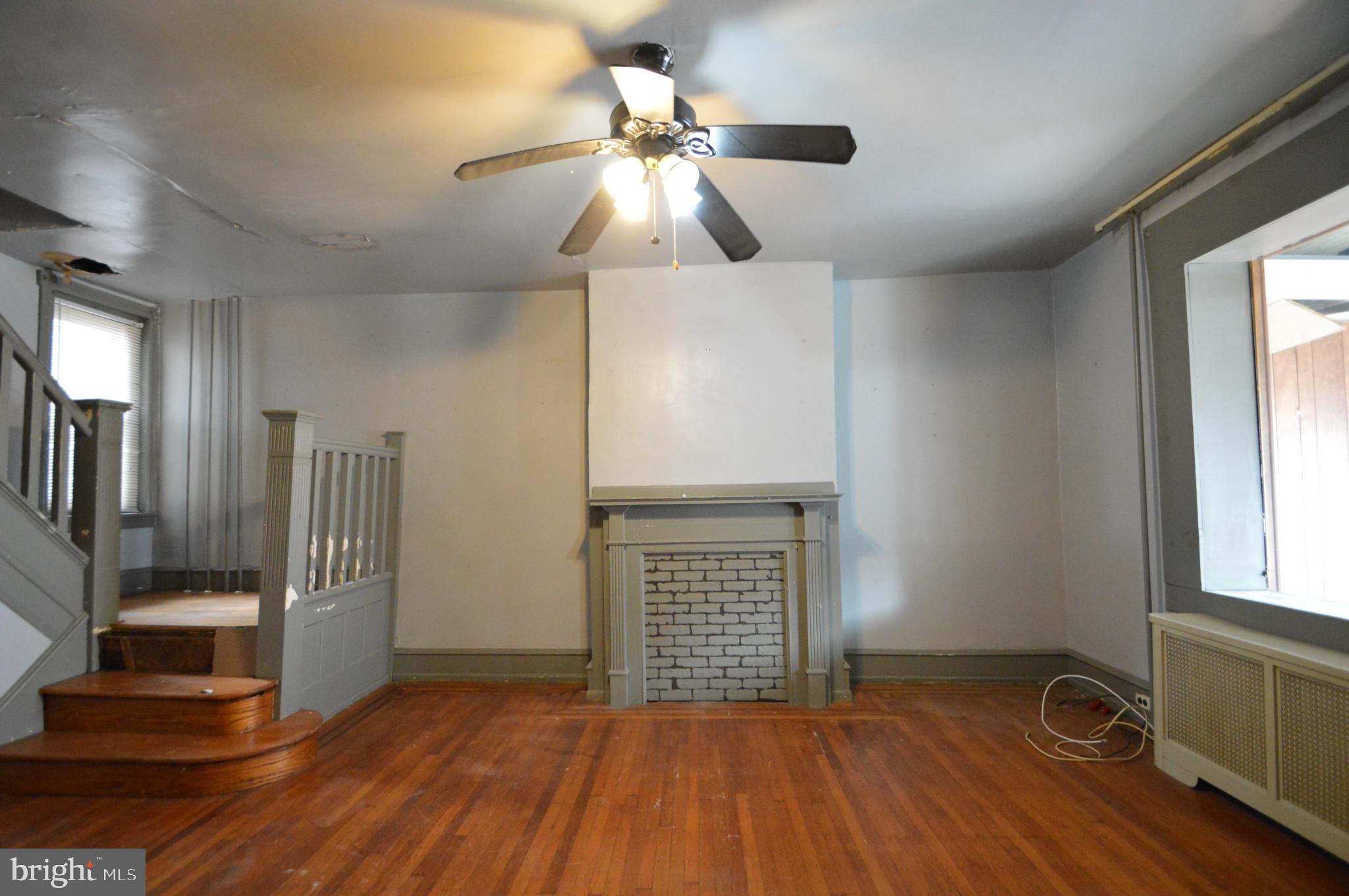 6011 Sansom Street Philadelphia, PA 19139 - Photo 3 of 24 a view of empty room with wooden floor and fan