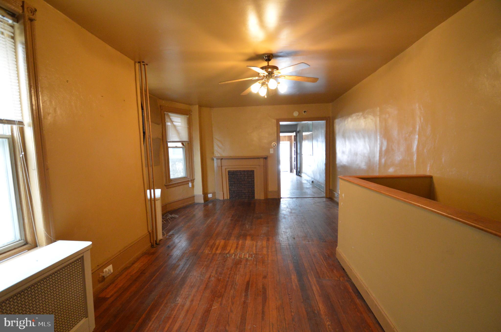 6011 Sansom Street Philadelphia, PA 19139 - Photo 7 of 24 a view of an empty room with wooden floor and a window