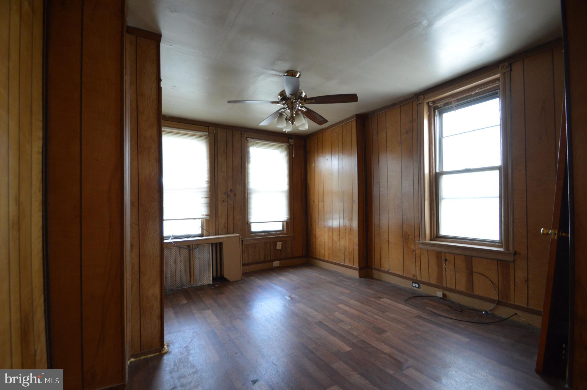 6011 Sansom Street Philadelphia, PA 19139 - Photo 8 of 24 an empty room with wooden floor and windows