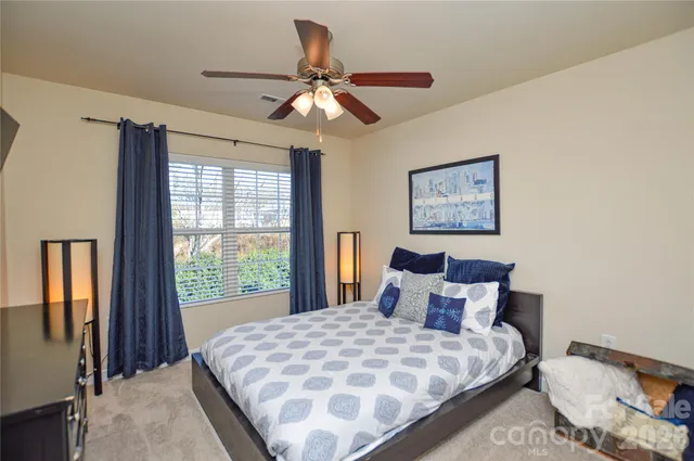 a bedroom with a large bed and a window