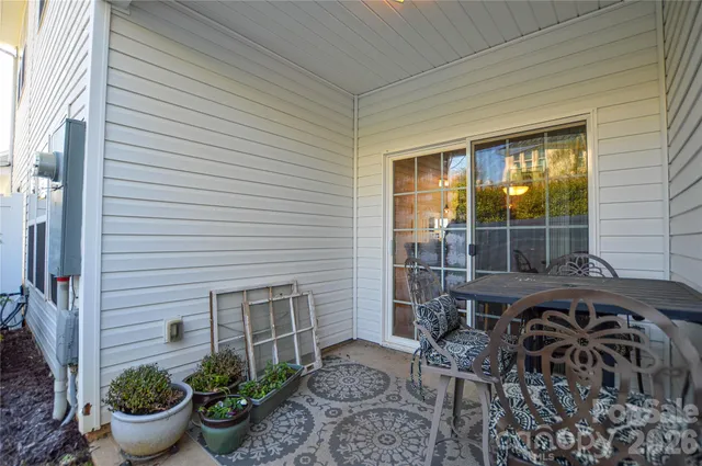 a view of a patio with table and chairs potted plants