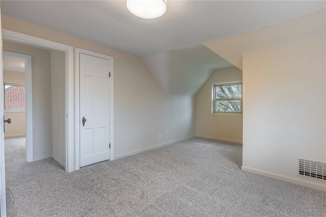 1012 Hampshire Road Dayton, OH 45419 - Photo 28 of 39 This cozy bedroom features sloped ceilings and ample natural light, creating a comfortable and inviting atmosphere.