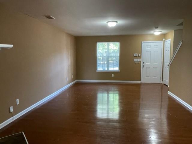 708 Crestwell Circle Atlanta, GA 30331 - Photo 4 of 23 a view of an empty room with wooden floor and a window