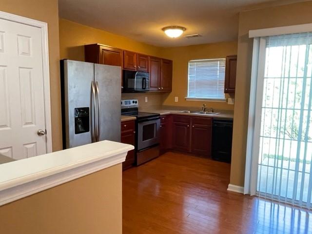 708 Crestwell Circle Atlanta, GA 30331 - Photo 7 of 23 a kitchen with stainless steel appliances a sink a stove a refrigerator and wooden floor