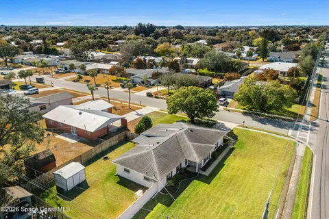 an aerial view of a house with a swimming pool