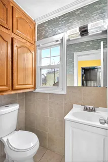 a bathroom with a toilet sink and mirror