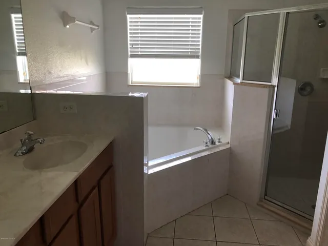 a bathroom with a bathtub sink and mirror