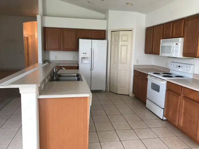 a kitchen with a stove a refrigerator and a sink