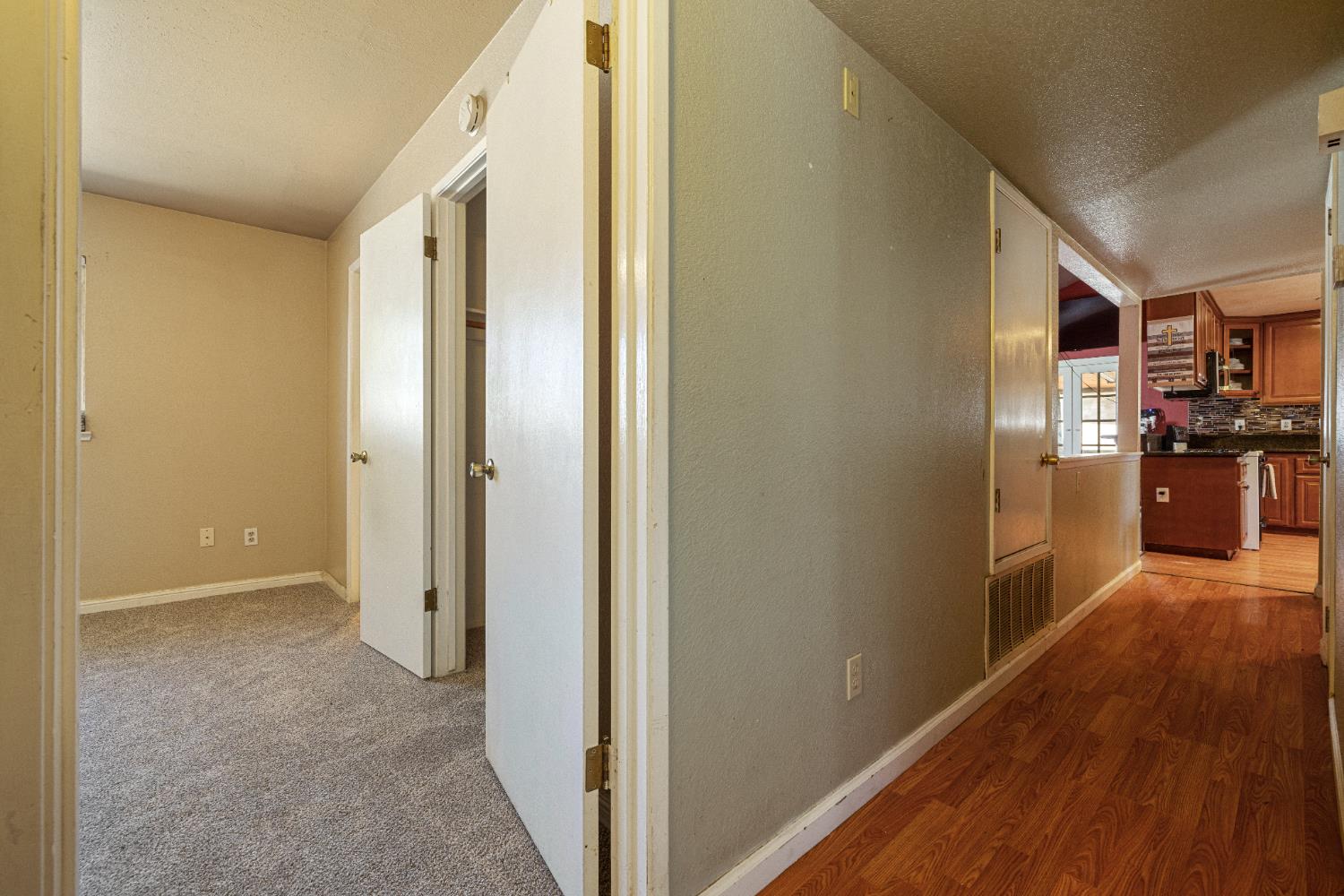 808 Cadillac Drive Modesto, CA 95351 - Photo 12 of 41 hall featuring a textured ceiling and baseboards