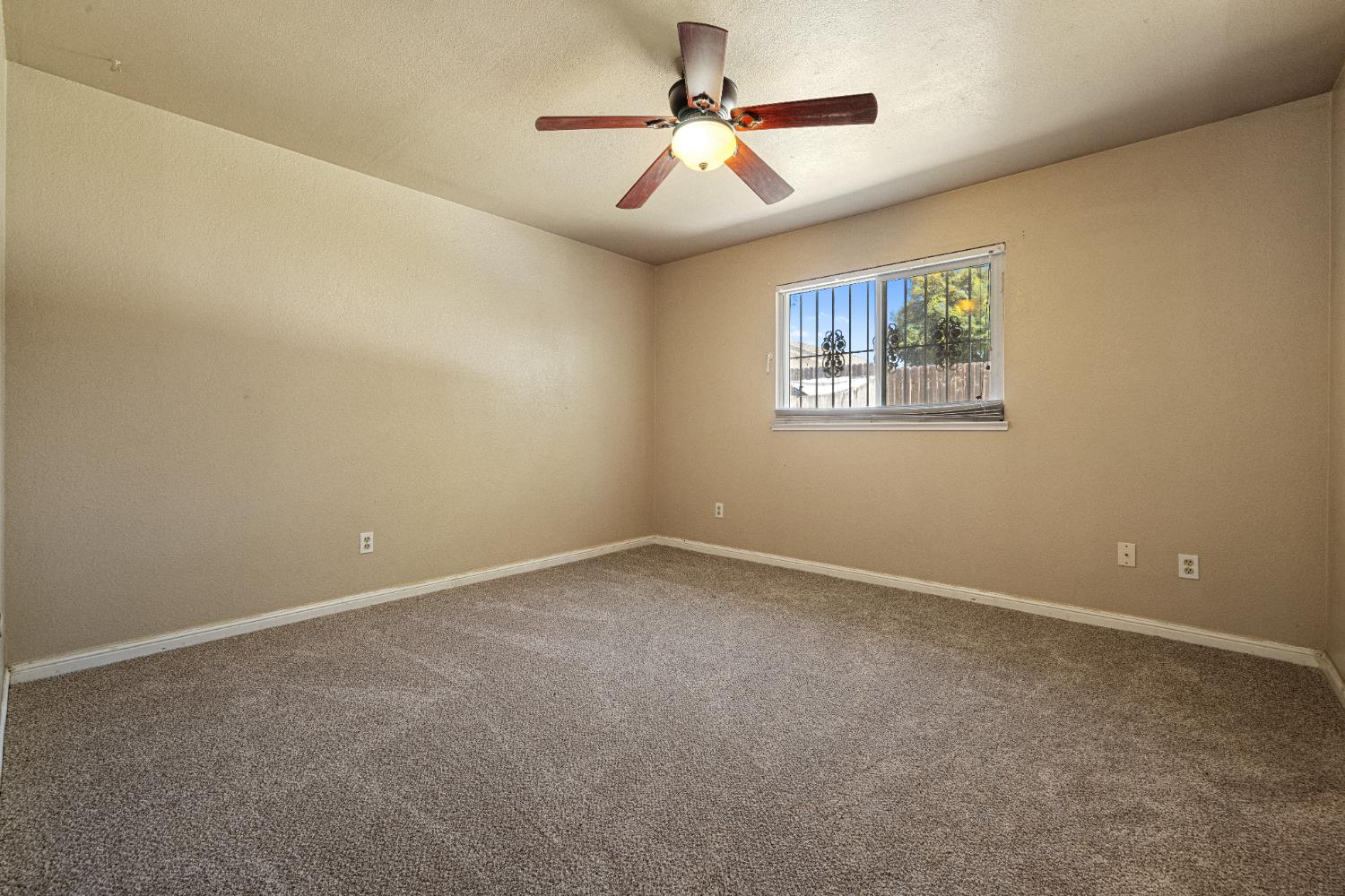 808 Cadillac Drive Modesto, CA 95351 - Photo 13 of 41 Enjoy the brand new carpet in the primary bedroom with walk in closet and primary bathroom.