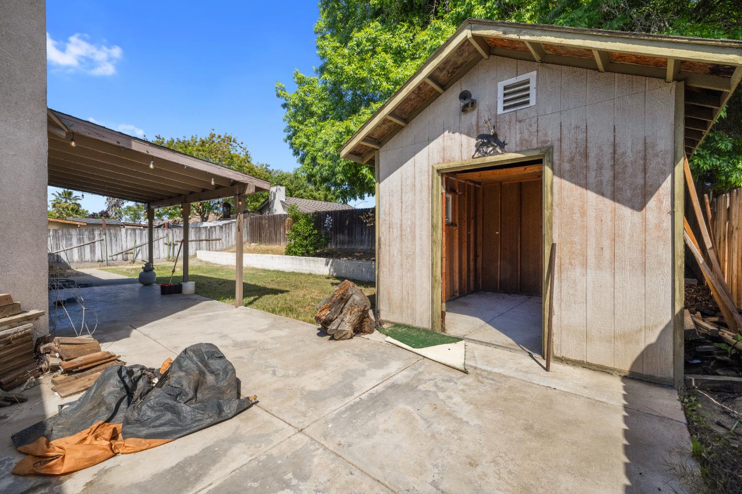 808 Cadillac Drive Modesto, CA 95351 - Photo 27 of 41 fenced backyard with a storage shed