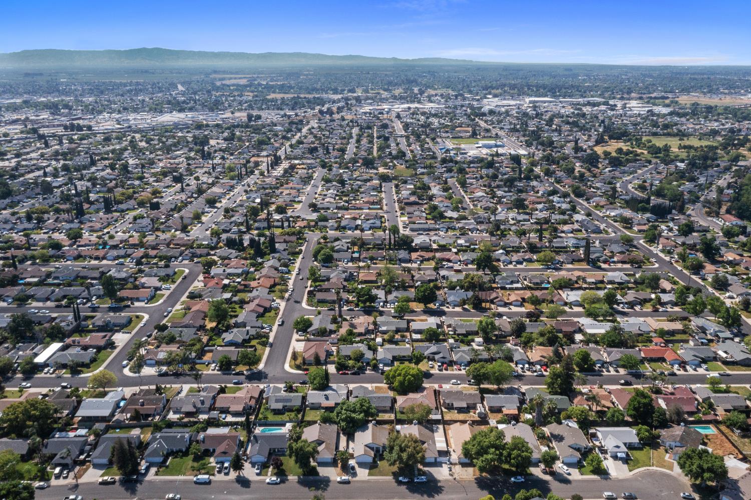808 Cadillac Drive Modesto, CA 95351 - Photo 29 of 41 aerial view of property and surrounding area with mountains and nearby suburban area