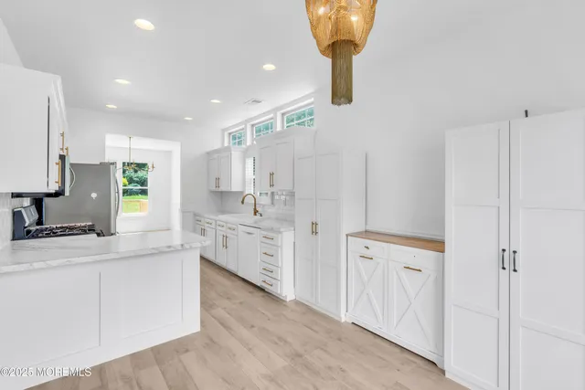 a large kitchen with a lot of counter space and a sink