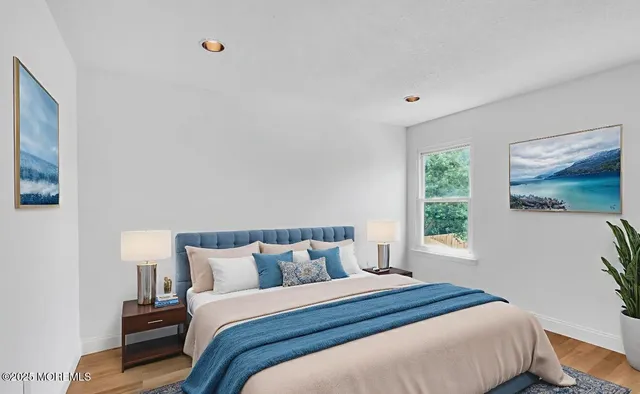 a bedroom with a bed and a painting