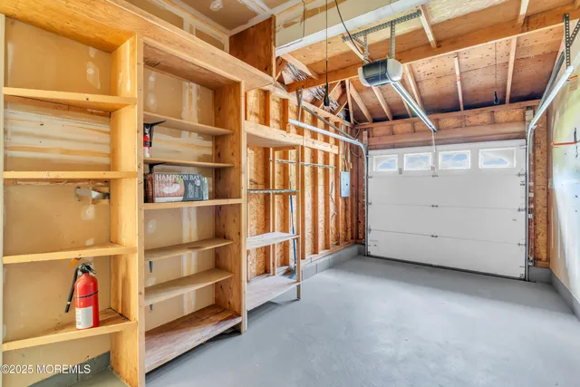 a view of a room with wooden floor fan and windows