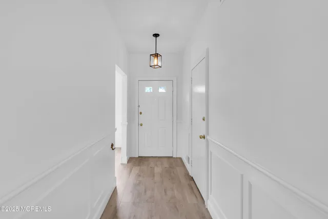 a view of a hallway with wooden floor and a hallway