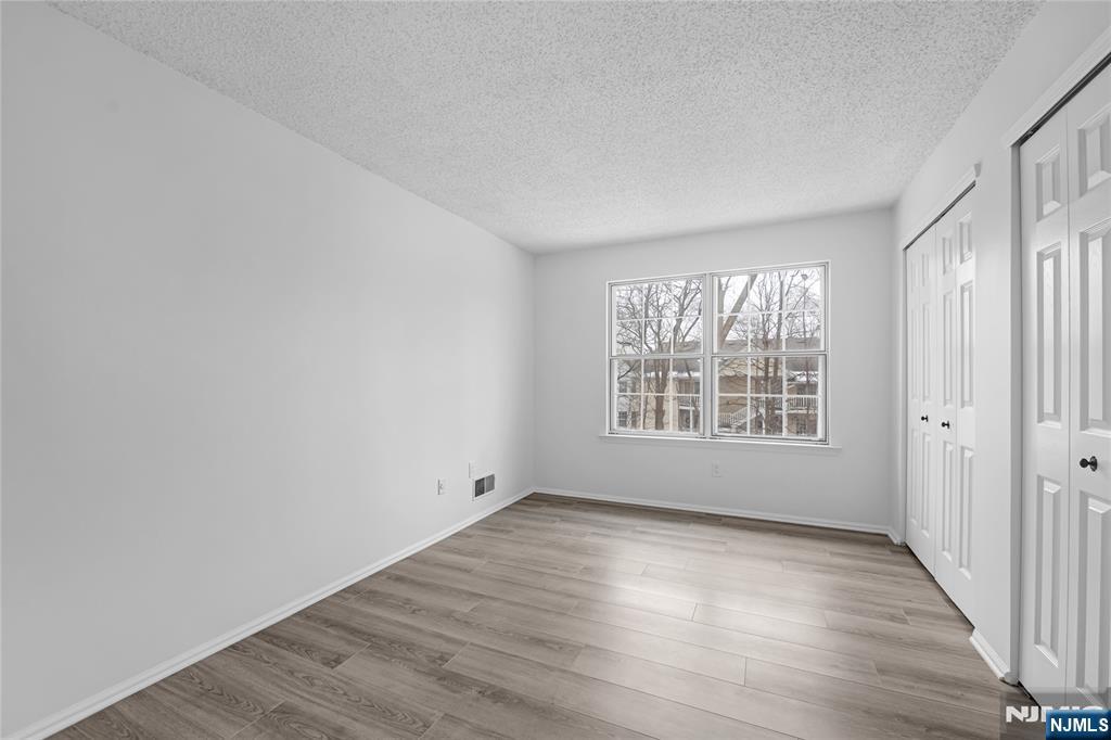 581 Holly Court Mahwah, NJ 07430 - Photo 12 of 21 a view of an empty room with wooden floor and a window