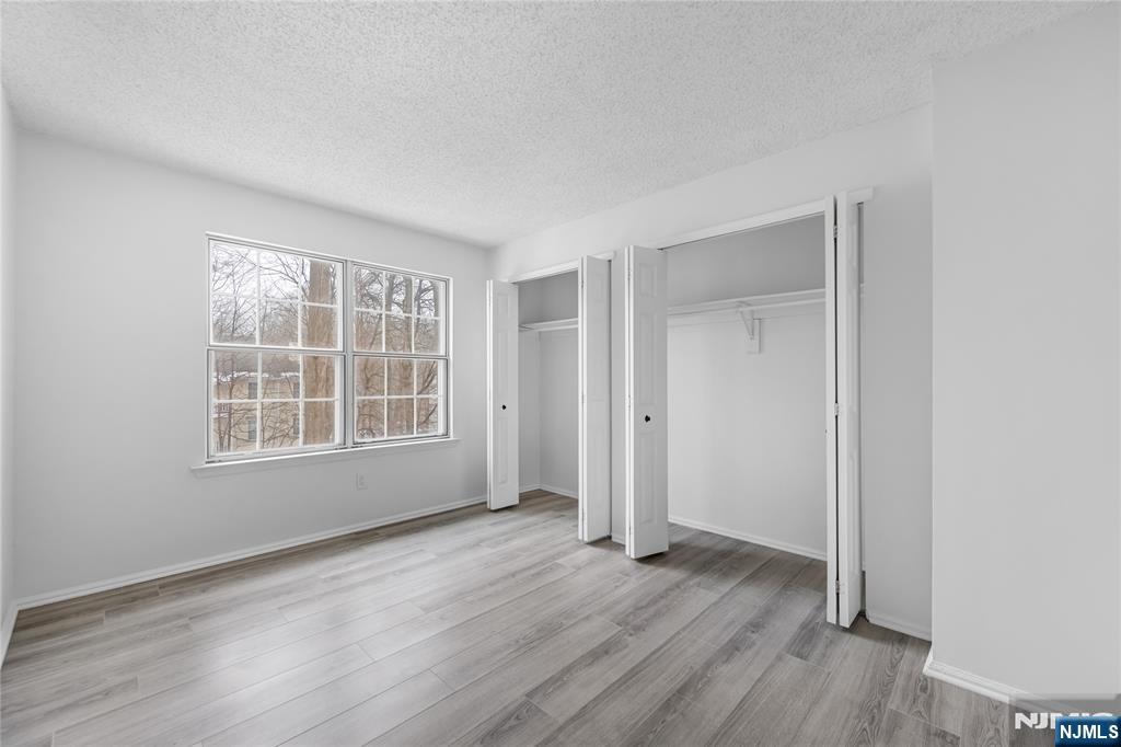 581 Holly Court Mahwah, NJ 07430 - Photo 13 of 21 an empty room with wooden floor and windows