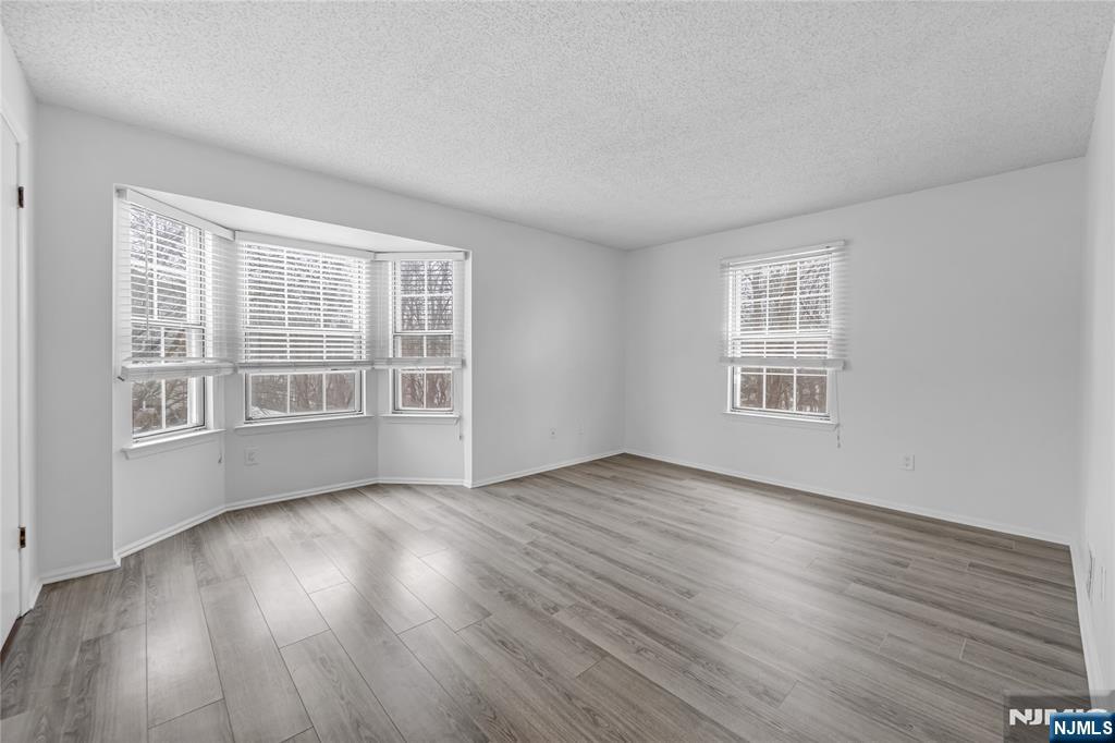 581 Holly Court Mahwah, NJ 07430 - Photo 16 of 21 a view of an empty room with wooden floor and a window