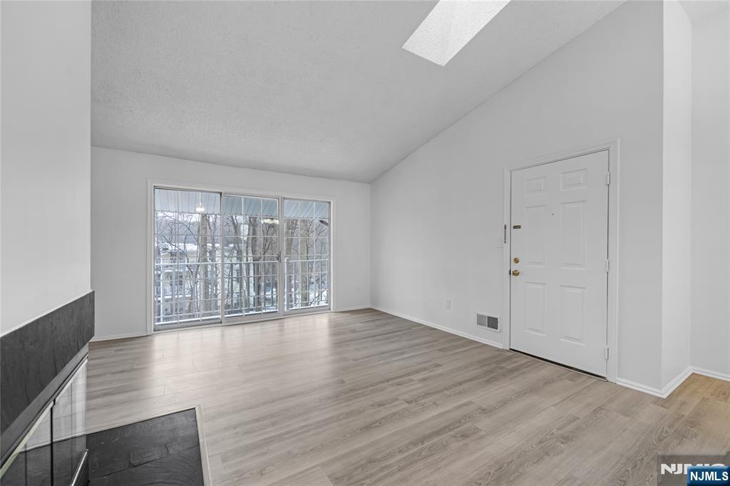 581 Holly Court Mahwah, NJ 07430 - Photo 4 of 21 wooden floor in an empty room with a window