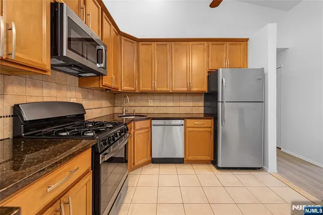 a kitchen with a stove a sink and a refrigerator