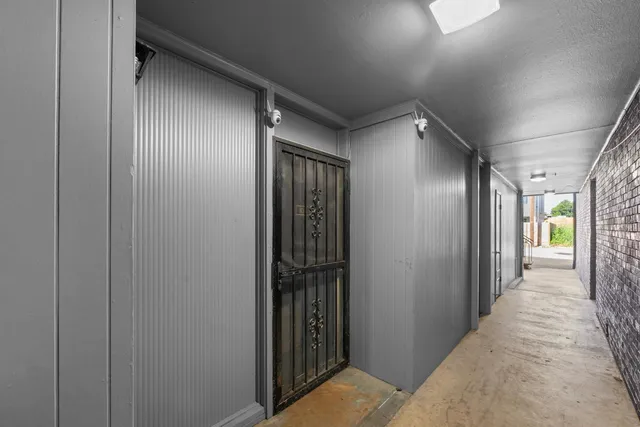 a view of hallway with wooden floor