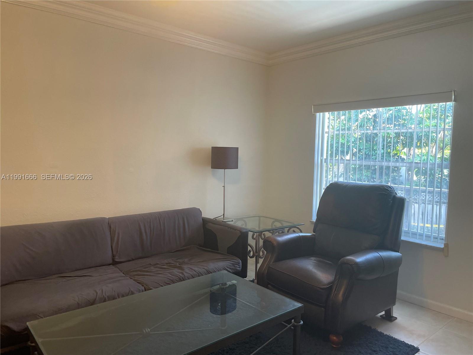 1405 Miami Road, Unit 23 Fort Lauderdale, FL 33316 - Photo 13 of 20 a living room with furniture and a window