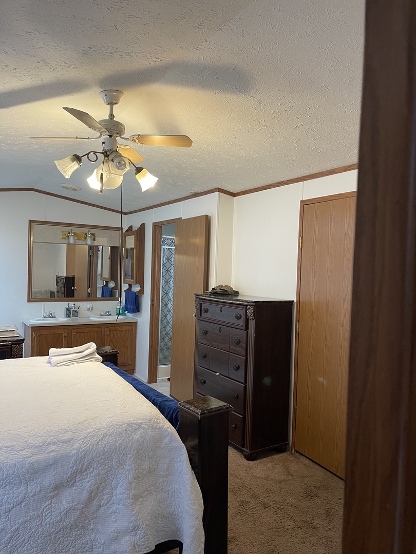365 Surrey Road Wheeling, IL 60090 - Photo 12 of 12 a bedroom with a bed and a chandelier