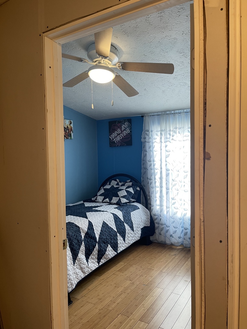 365 Surrey Road Wheeling, IL 60090 - Photo 6 of 12 a bedroom with a bed and wooden floor