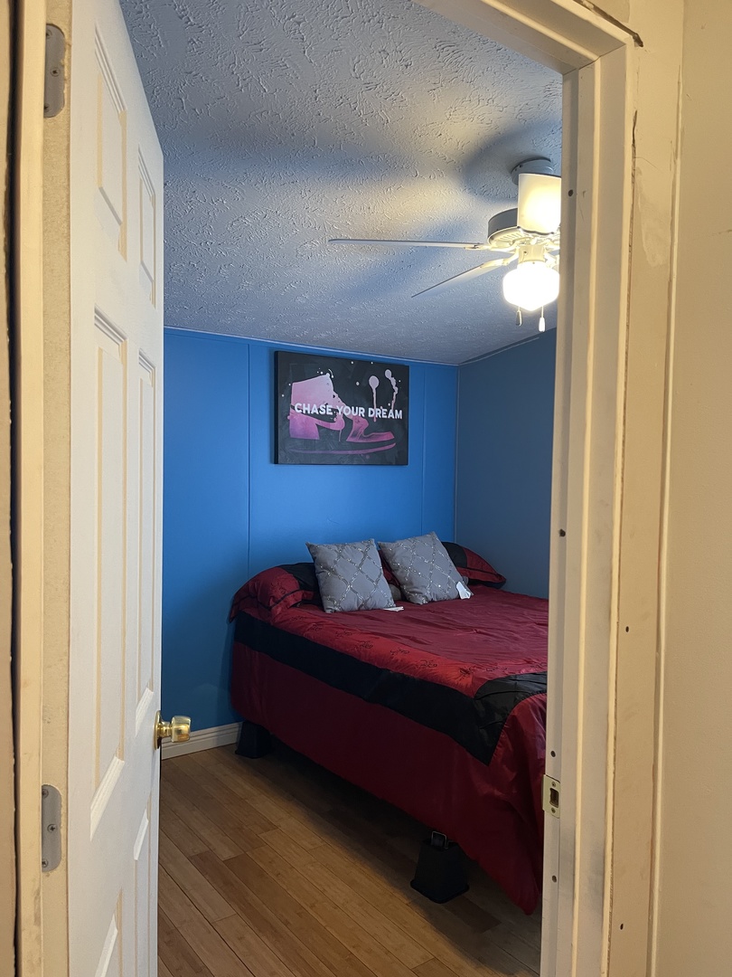 365 Surrey Road Wheeling, IL 60090 - Photo 7 of 12 a bedroom with a bed and a painting on the wall