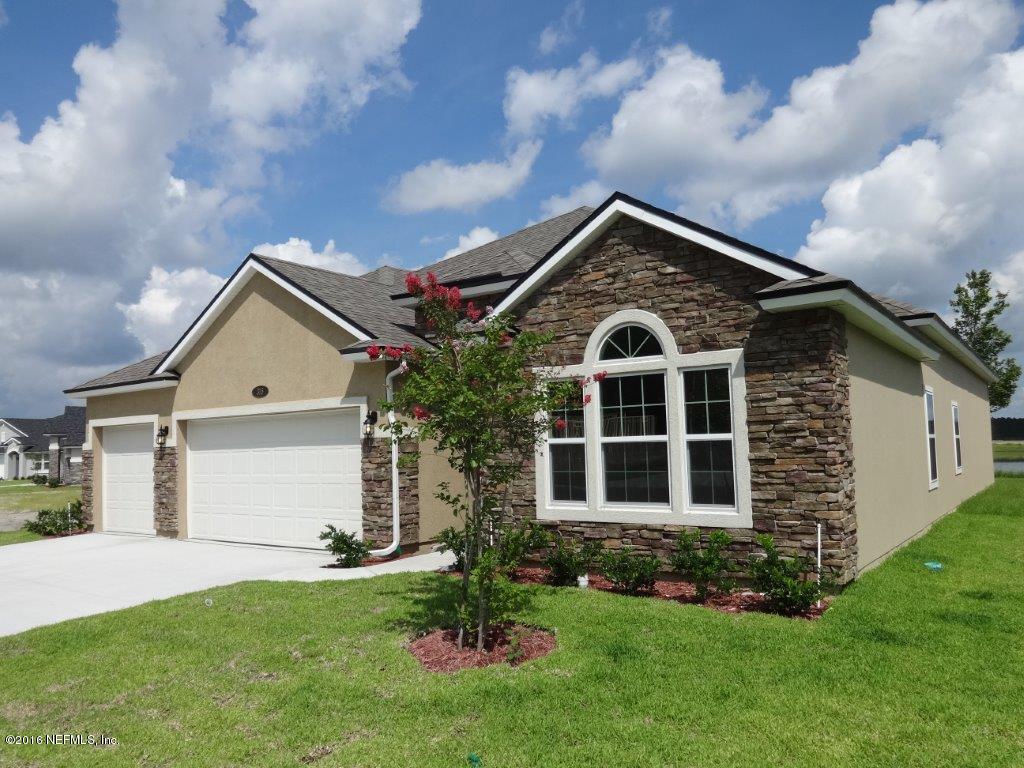 316 Crescent Key Drive St. Augustine, FL 32086 - Photo 12 of 45 a front view of a house with a yard and garage