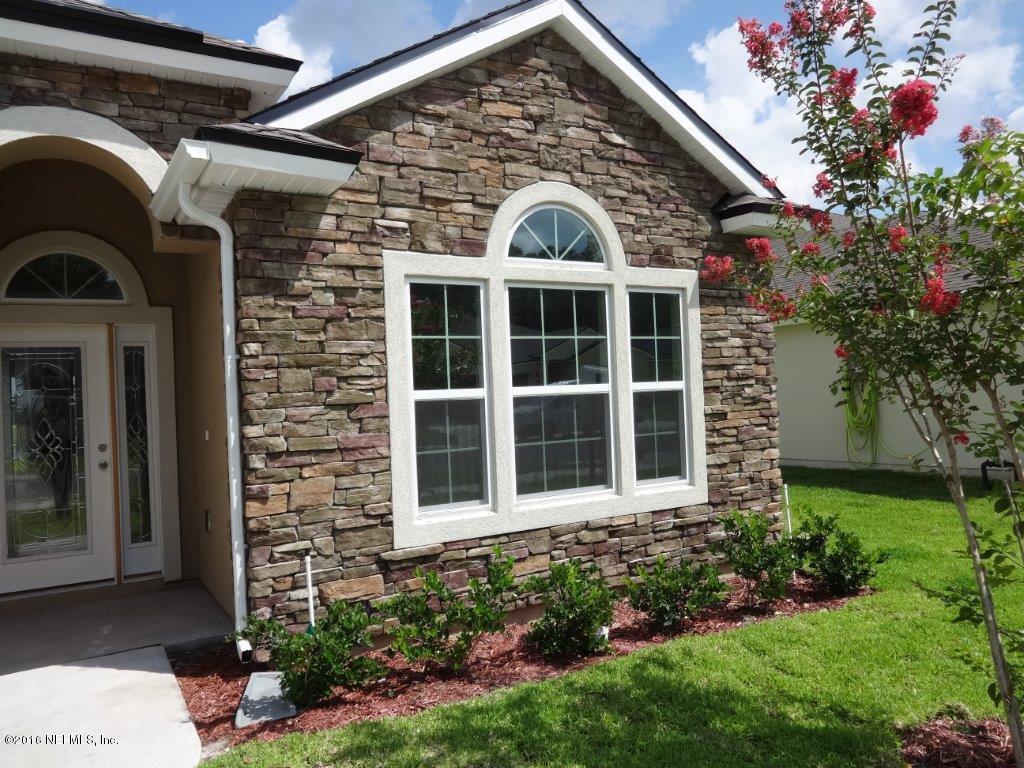 316 Crescent Key Drive St. Augustine, FL 32086 - Photo 14 of 45 a front view of a house with a garden