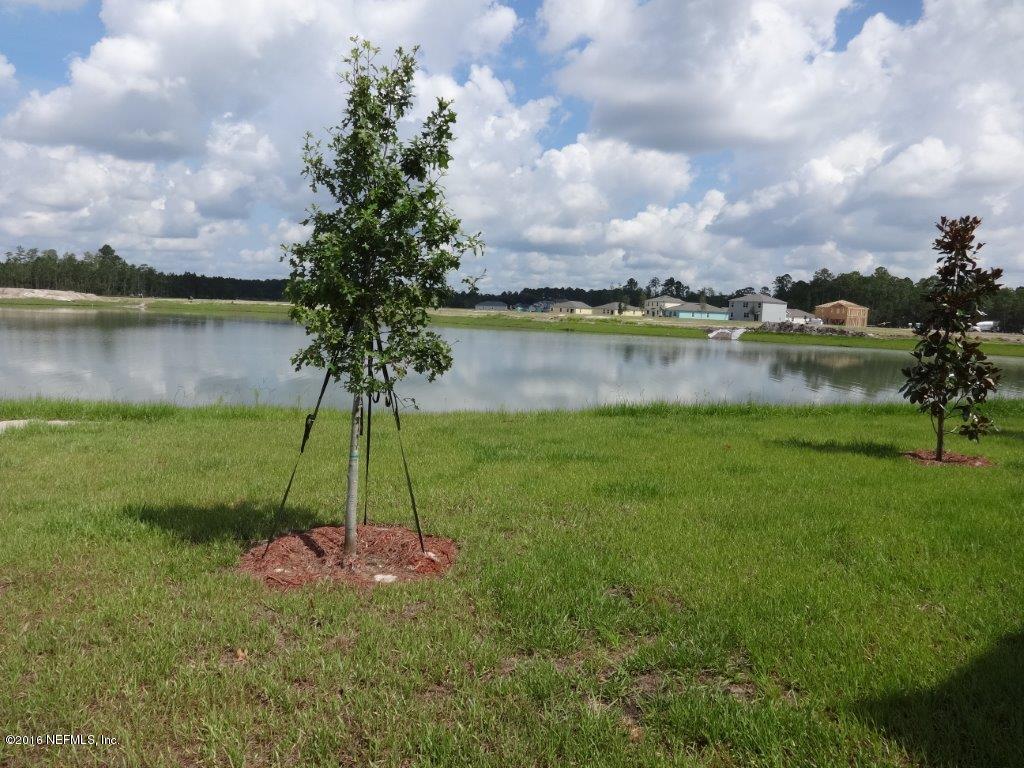 316 Crescent Key Drive St. Augustine, FL 32086 - Photo 16 of 45 a view of a lake with a big yard