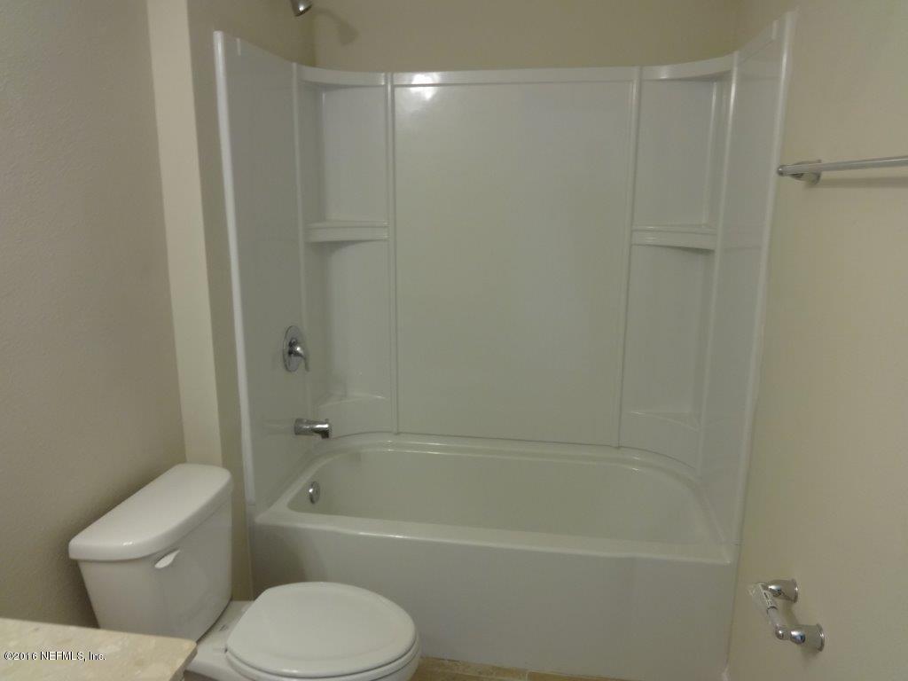 316 Crescent Key Drive St. Augustine, FL 32086 - Photo 23 of 45 a bathroom with a toilet and a bathtub