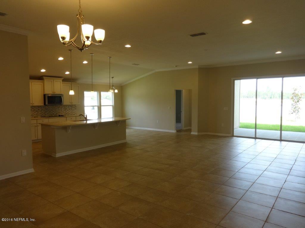 316 Crescent Key Drive St. Augustine, FL 32086 - Photo 26 of 45 a view of a kitchen with a sink and chandelier