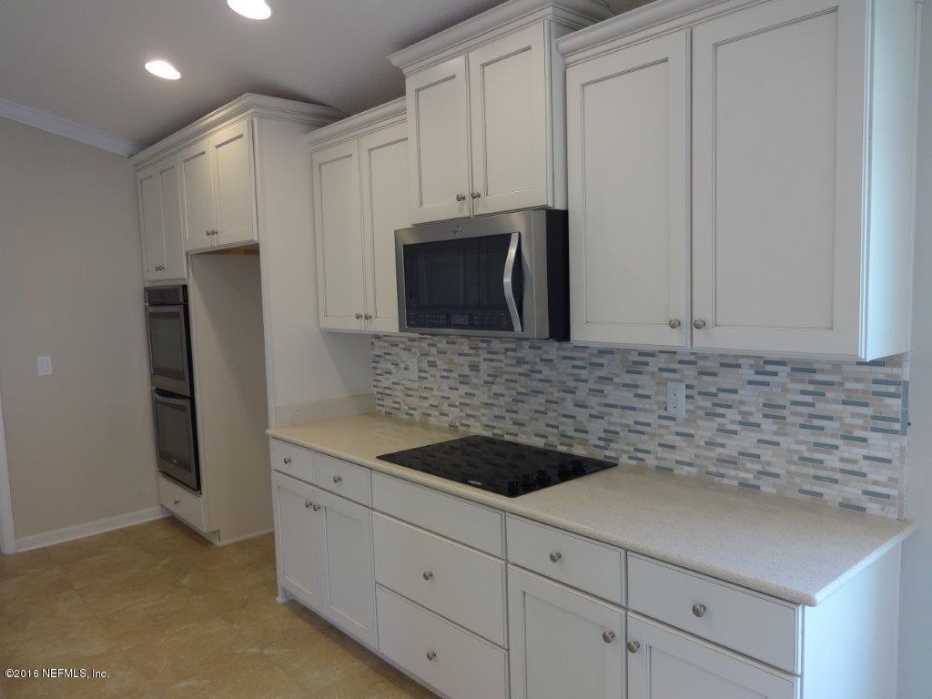 316 Crescent Key Drive St. Augustine, FL 32086 - Photo 31 of 45 a kitchen with granite countertop white cabinets and stainless steel appliances