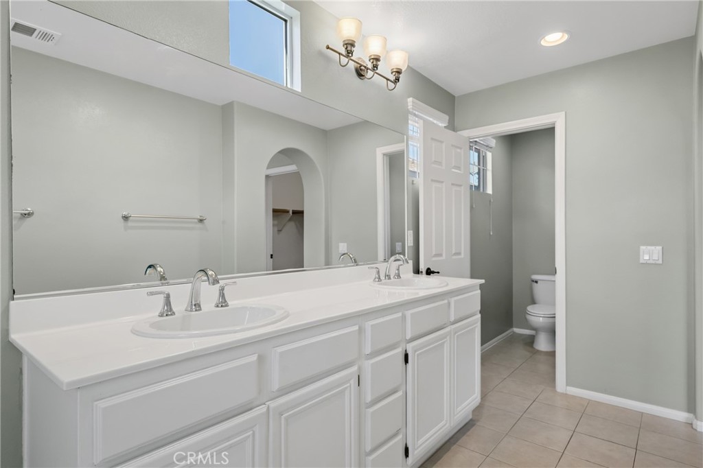 25 Amy Way Ladera Ranch, CA 92694 - Photo 20 of 47 a spacious bathroom with a double vanity sink mirror and toilet