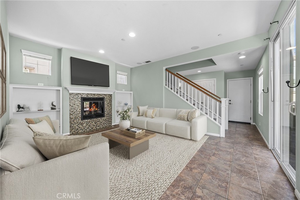 25 Amy Way Ladera Ranch, CA 92694 - Photo 2 of 47 a living room with furniture a flat screen tv and a fireplace