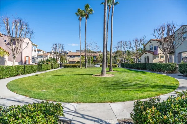 an aerial view of a residential houses with yard