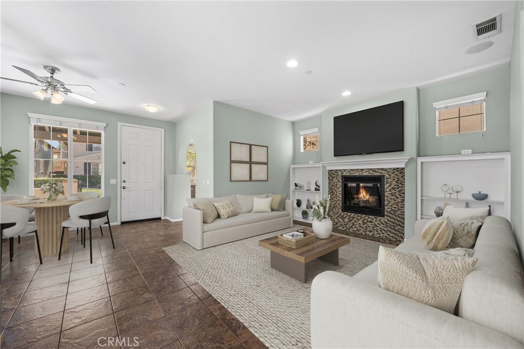 25 Amy Way Ladera Ranch, CA 92694 - Photo 4 of 47 a living room with furniture a fireplace and a flat screen tv