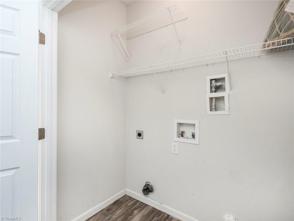 4705 Fewell Road Greensboro, NC 27405 - Photo 13 of 23 The laundry closet is located between two guest bedrooms.